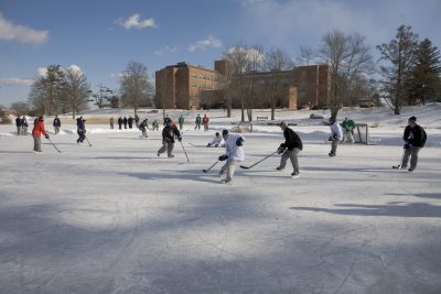 Image of students playing ice hockey on Swan Lake, UConn Storrs Campus.